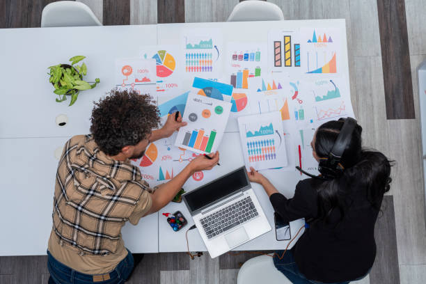 istock Fair-haired gay co-workers are in their office working on a business plan 1404723529