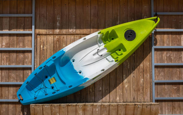 istock A plastic  colorful kayak hung on a wooden wall 1404723759