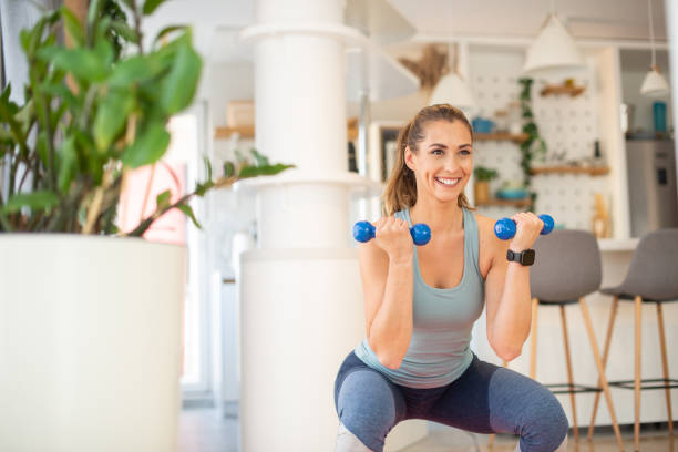 istock Young woman at home keeping fit by exercising 1404723966