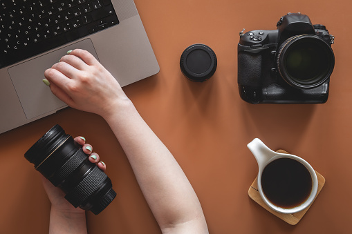 Flat lay composition with photographer's equipment and accessories on color background.