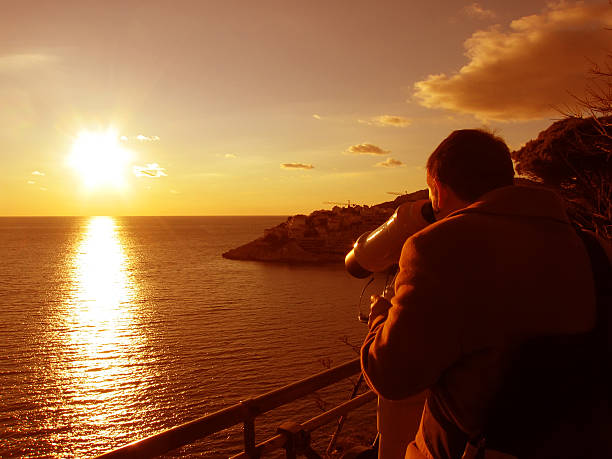 istock Man with telescope looks on sunset 140472511