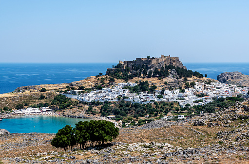 Panoramic view of Lindos bay, the village and the Akropolis of Lindos in Rhodes island, Greece.Panoramic view of Lindos bay, the village and the Acropolis of Lindos in Rhodes island, Greece.