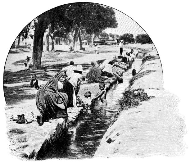 istock People Bathing and Doing Laundry at a Canal in Cholula, Mexico - 19th Century 1404725441