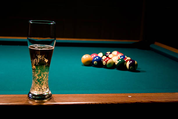 Glass of beer on the pool table stock photo