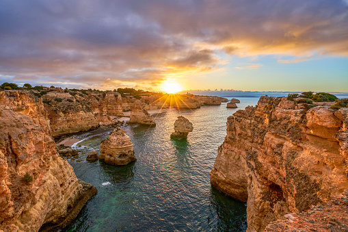 Sunrise at Praia da Marinha's Rocky Cliffs along the famous Algarve Coast in Southern Portugal, Europe.