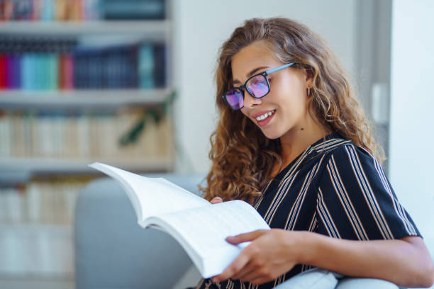 istock Young beautiful student girl working, learning in college library. 1404726286