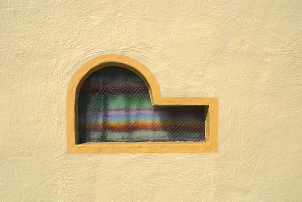 Mexican Window Mexican blanket curtains through architecturally interesting window. misshaped stock pictures, royalty-free photos & images