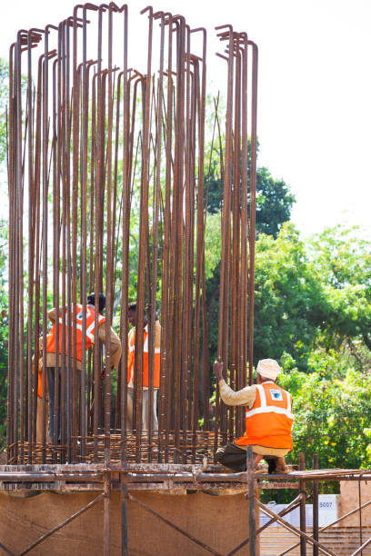 A Midday view of a Civil Concrete roofing work in progress with a dedicated team of Mason workers on a second floor  construction site in Mysuru,India.