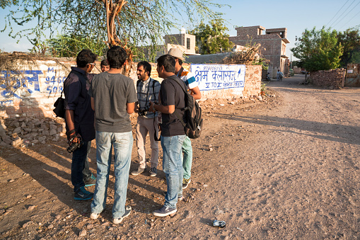 Jodhpur, India - March 5, 2015. A group of young men talking along a street in the city of Jodhpur in Rajasthan, India.