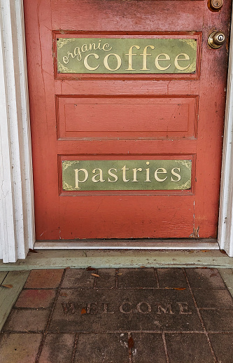 Red door entrance to an organic coffee and pastries country store. Country store that makes pastries and organic coffee.