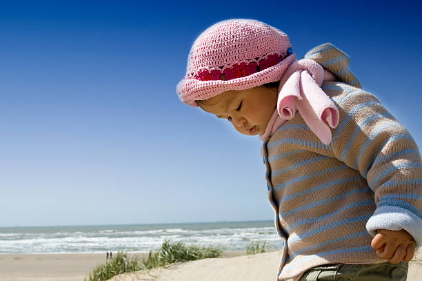 little girl on the beach stock photo