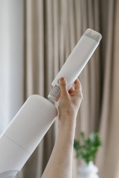 istock Woman change small brush on a handheld vacuum cleaner 1404735379