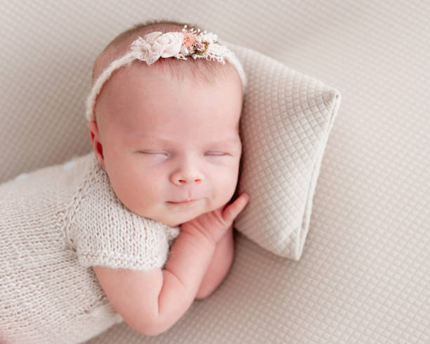 istock newborn baby sleeping on a little pillow 1404735506