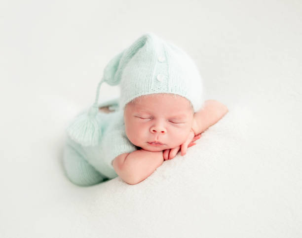 istock newborn baby sleeping in mint clothes 1404735510