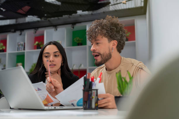 istock Fair-haired gay co-workers are in their office working on a business plan 1404737210