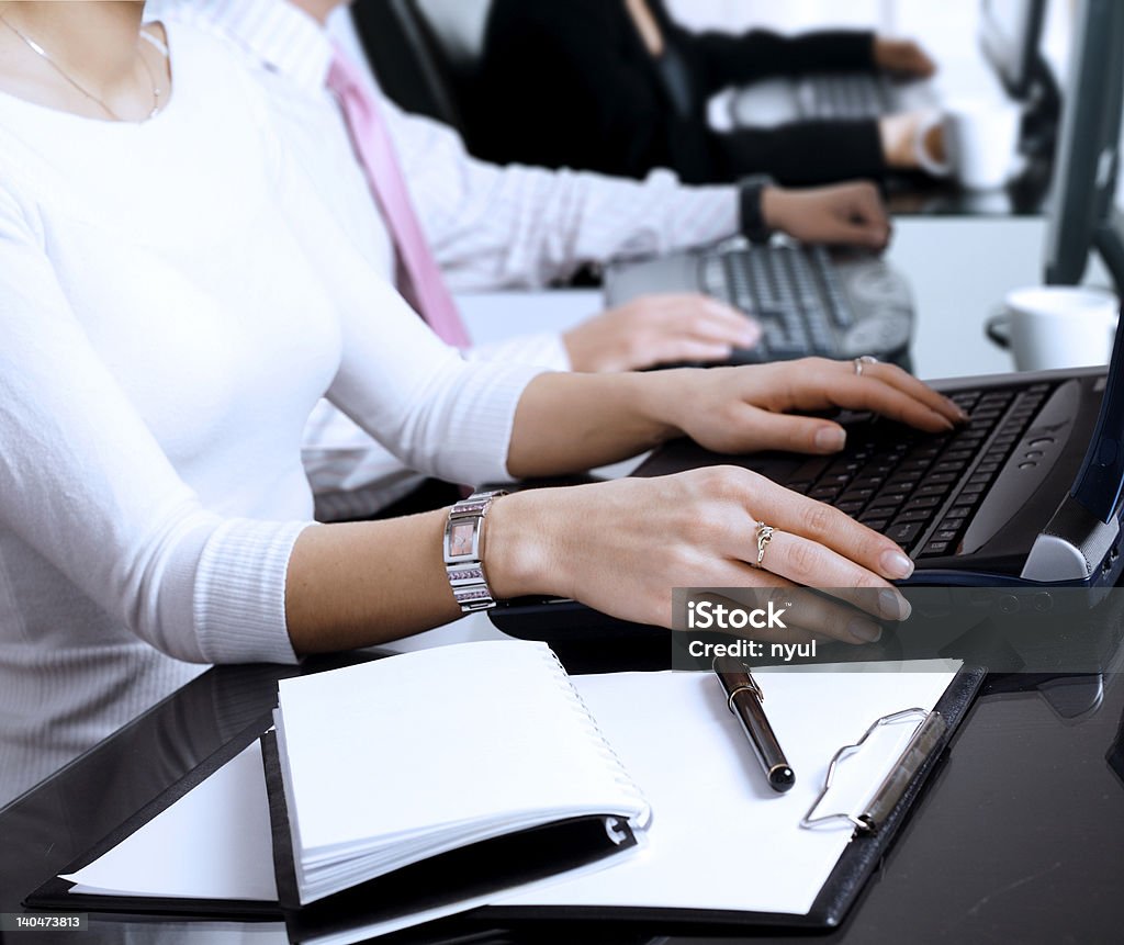 Using computer Close-up os human hands. Young office workers are typing on keyboards in front of their office computers. Computer Monitor Stock Photo