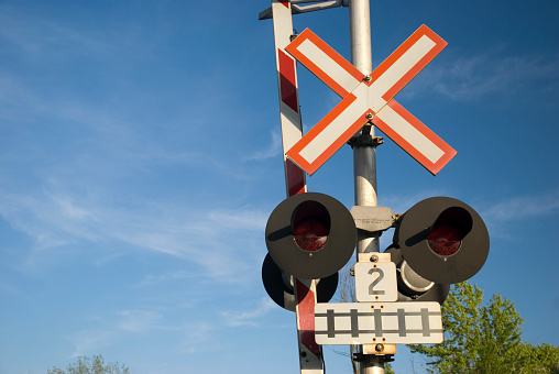 Rail road crossing with lights and barrier.