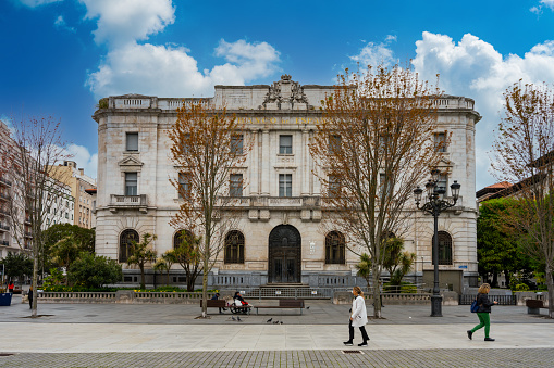 Santander, Spain - May 4th 2022 - People passing the Front of the Bank of Spain in Santander
