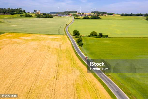 Tractor Driving On Coutry Road In Idyllic Spring Landscape Aerial View Stock Photo - Download Image Now
