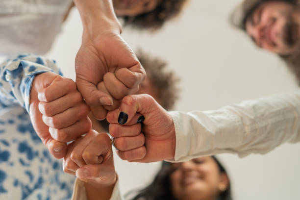 istock The average formally dressed 30 year old gay co-worker stands just joining hands for the photograph 1404740113
