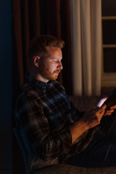 istock A Serious Ginger Businessman Working Night Shift From Home Using His Tablet 1404741259