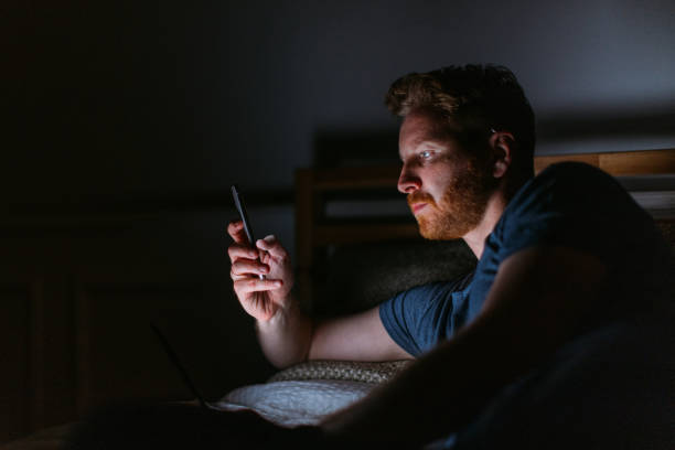 A Serious Ginger Businessman Being Online On His Mobile Phone While Relaxing At Home stock photo