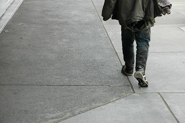 closeup of man walking in the street from the market with bags of fruits and vegetables