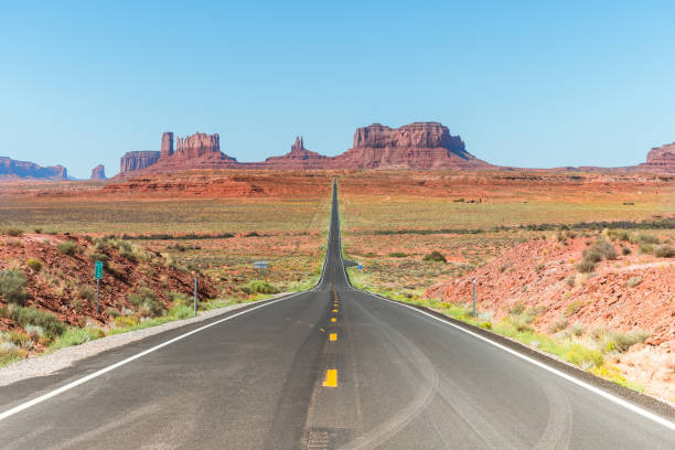 monument valley is an american famous park located between the borders of utah and arizona views of monument valley national park with famous buttes formations at background route 66 stock pictures, royalty-free photos & images