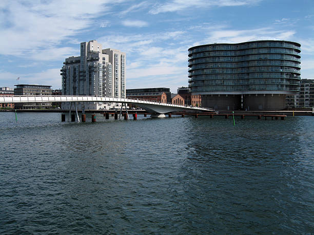 Islands Brygge View of Islands Brygge in Copenhagen and the pedestrian bridge linking it to the other side of the harbour. alintal stock pictures, royalty-free photos & images