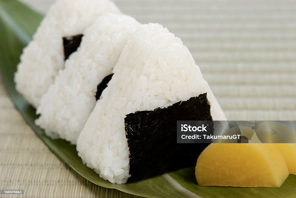 Japanese Rice Ball The rice ball which is mobile food from old days is essential at the time of going out in Japan. Love of mother is put to grasp by one to a rice ball by hand.By the present age, it is the representative food which mother shows love to a child in. Business Stock Photo