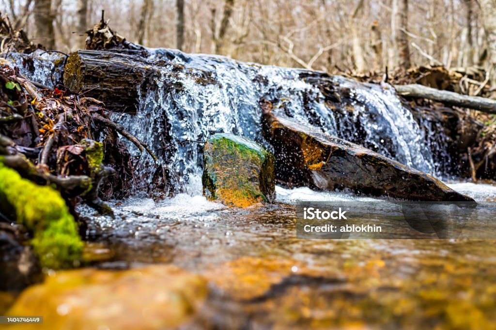Small waterfall river stream water flowing in Shamokin Springs Nature preserve hiking trail in Wintergreen Resort in Virginia closeup low angle ground level view Virginia - US State Stock Photo