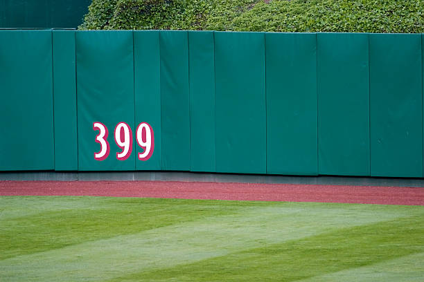 Outfield Wall The distance measurement on the outfield wall of a baseball stadium. outfield stock pictures, royalty-free photos & images