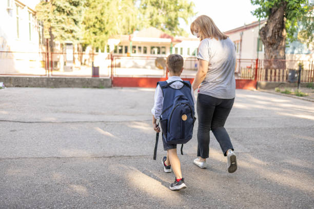 istock Mom taking son to school 1404747287