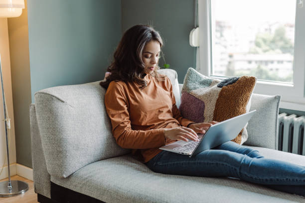 istock Mixed race young woman using laptop and concentrates on her work 1404747445