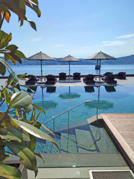 istock Deck chairs on Wooden plank floor against swimming pool 1404747612
