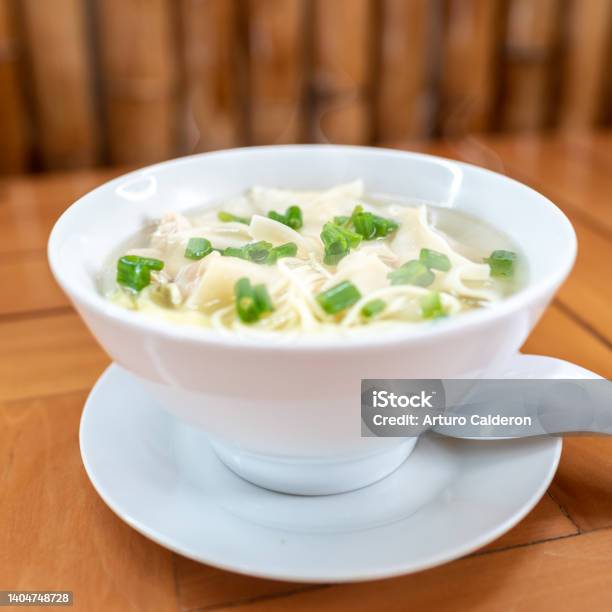 Wuantan Soup With Chicken Noodles And Chinese Onion Chifa Stock Photo - Download Image Now