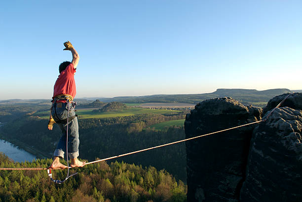 Man walking on highline above beautiful view of trees walk the line highlining stock pictures, royalty-free photos & images