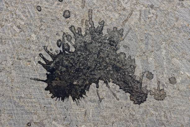 istock one black dirty spot of paint on a gray surface 1404752286