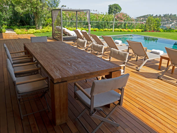istock Deck chairs on Wooden plank floor against swimming pool 1404752290