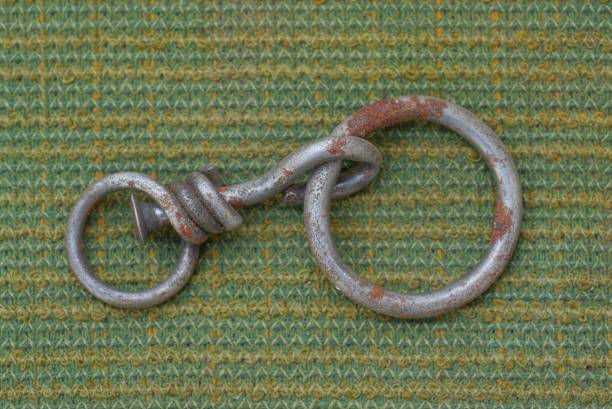 one old gray metal fastener with a ring in brown rust
