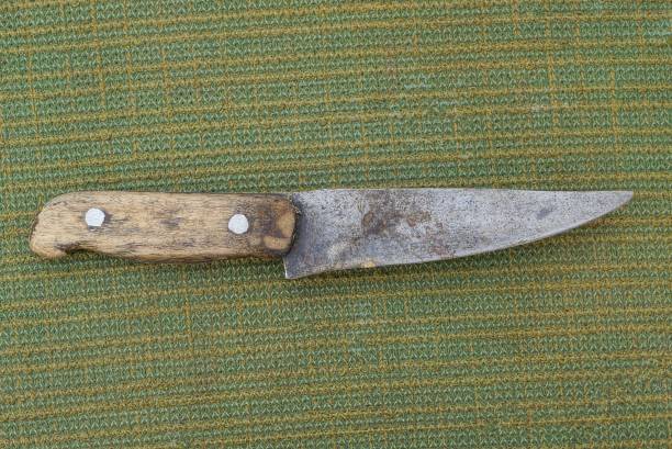 istock one old gray knife with a brown wooden handle 1404752486