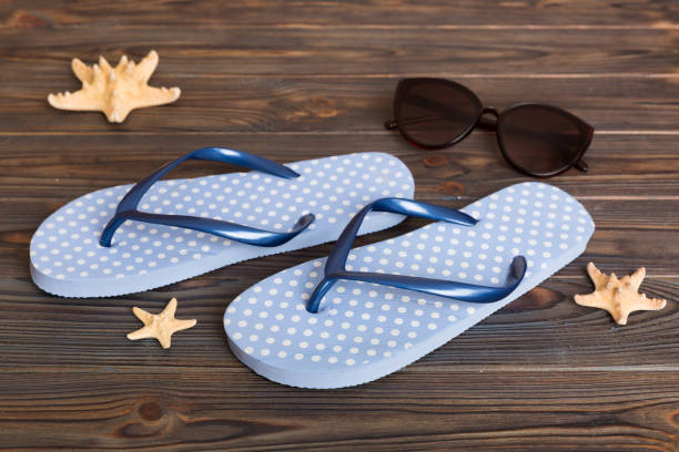 istock Beach accessories. Flip flops and starfish on colored background. Top view Mock up with copy space 1404753429