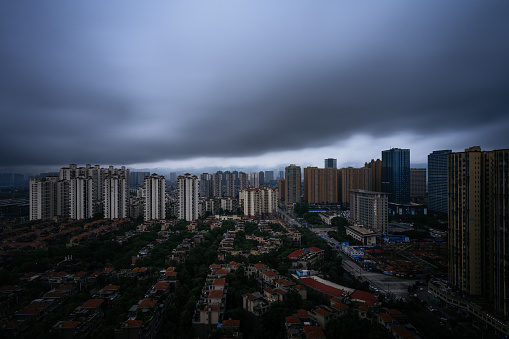 Residential buildings under dark clouds