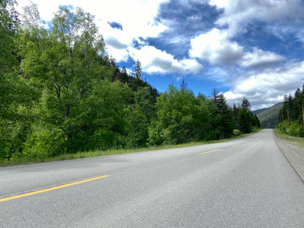 istock Scenic road with blue sky and clouds 1404755440