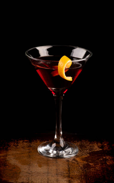 istock angle view martini glass with orange slice and cherry drink on dark background on wooden table 1404755588