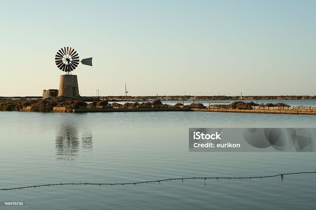 Windmill in Saltwork Old windmill in Trapani and Paceco Saltworks Horizontal Stock Photo