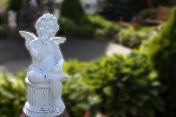 standing cupid statue with kissing