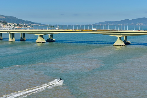 Landscapes in the city of Floriánópolis seen from the Hercilio Luz bridge, with the Pedro Ivo Campos bridge in the background, Santa Catarina, Brazil, overlooking the south bay with the sea and boats.