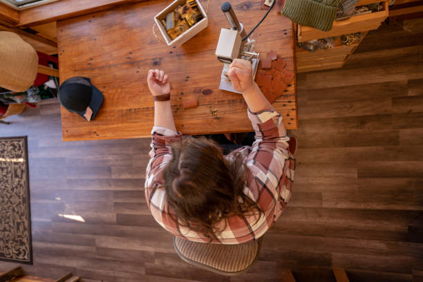 istock Overhead shot of woman working with leather in workshop 1404760295