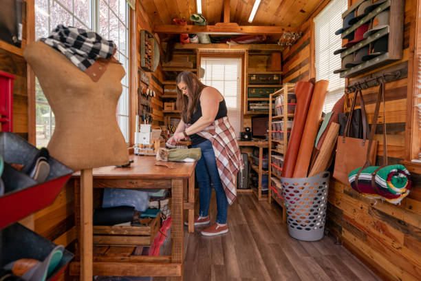 istock Craftswoman making leather jewelry in studio 1404760300